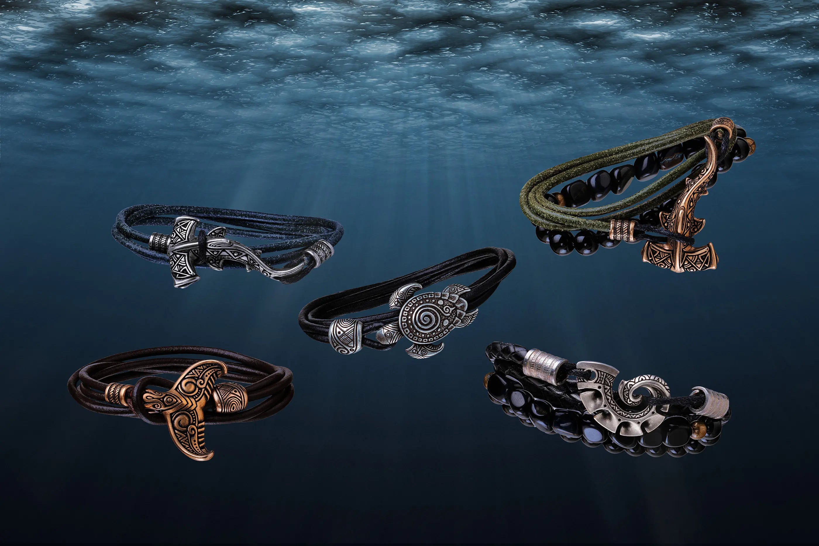 Five Norse-style Viking-themed bracelets with detailed metal carvings and charms, displayed against a dark blue underwater background with light rays filtering through.